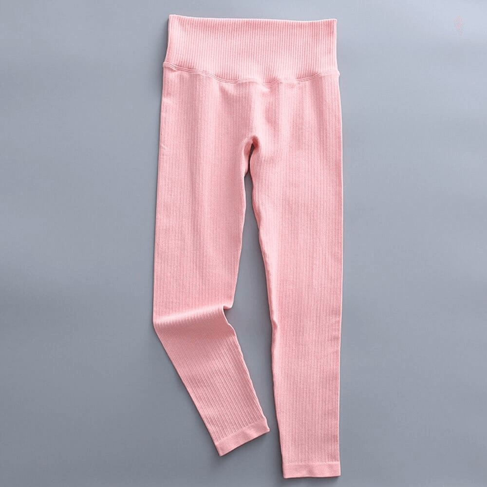 Pink seamless high-waist ribbed leggings for women, ideal for yoga and exercise, featuring stretchable nylon and spandex fabric.